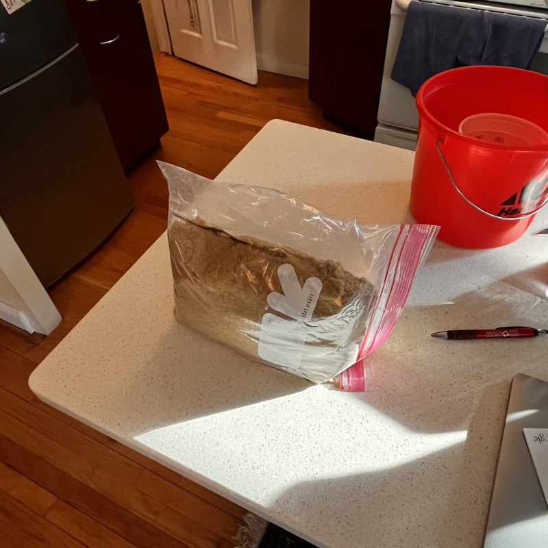 Measuring sand into a freezer bag